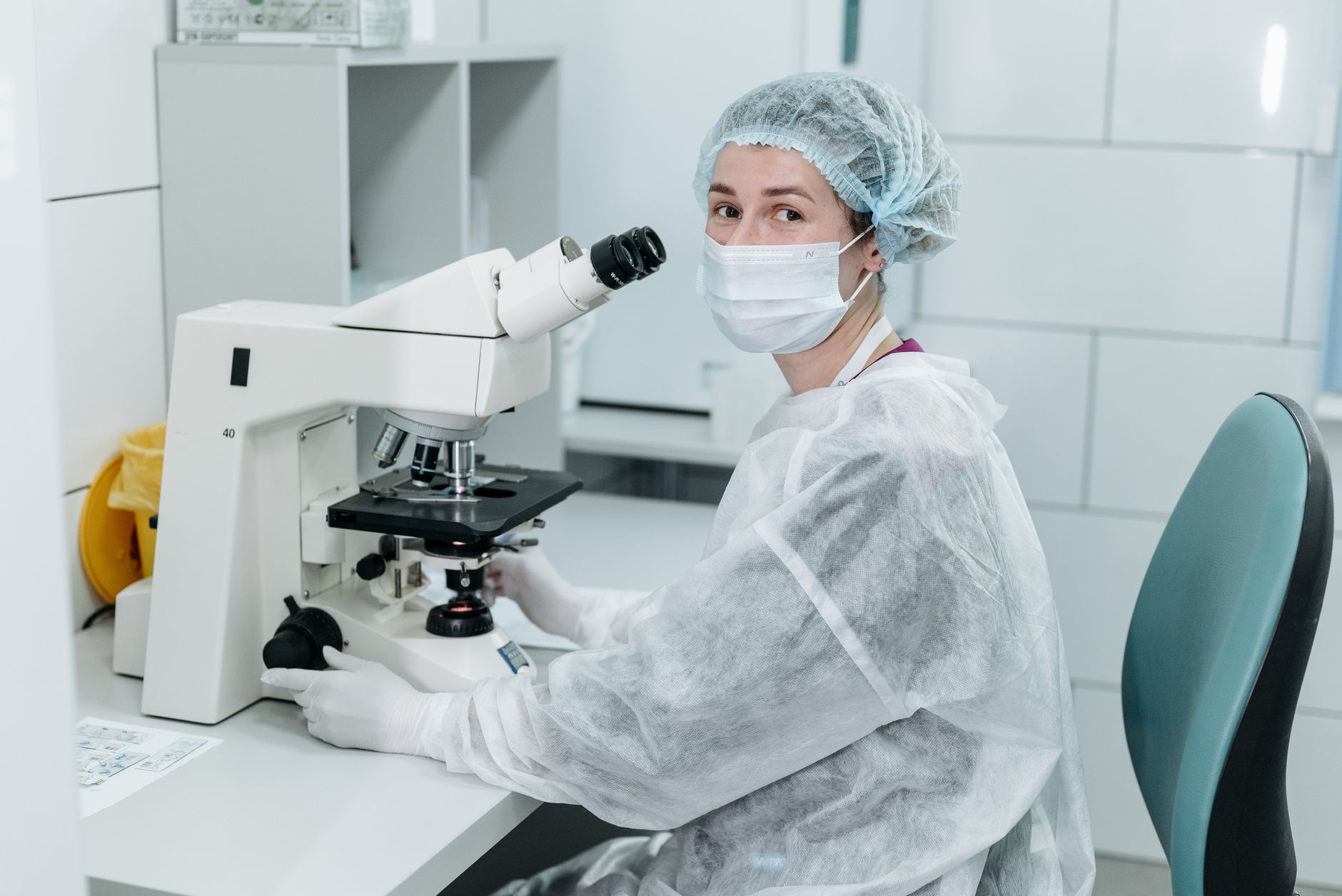 A medical specialist working with laboratory equipment to analyze research results